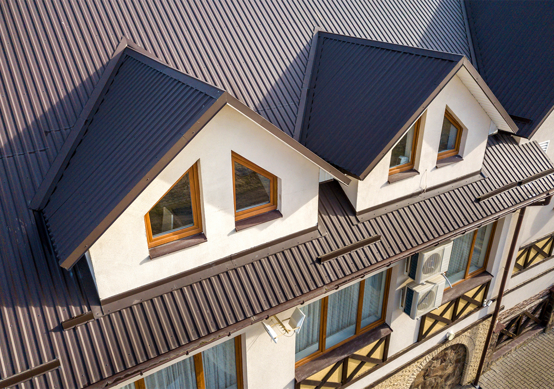 Building with metal shingle roof, stucco walls and plastic windows